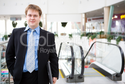 Happy young businessman with laptop