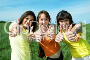 happy three friend show sign ok in green field