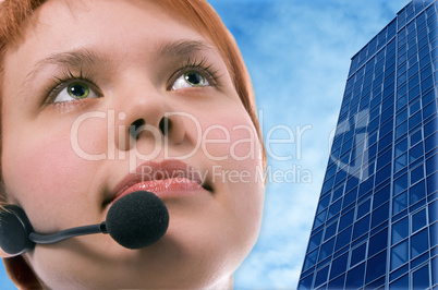 woman operator with headphoneson blue sky and business buildings