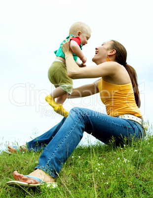 Mother with  baby  on the meadow