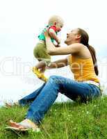 Mother with  baby  on the meadow