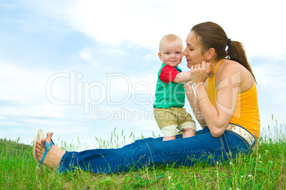 Mother with  baby  on the meadow