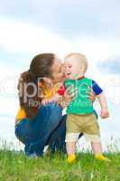 Mother with  baby  on the meadow