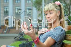 blonde girl sit on bench