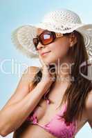 Young beautiful sexy tanned brunette woman in hat and bikini