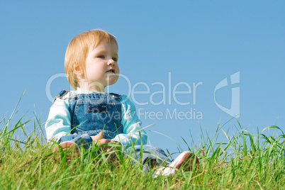 child on green grass