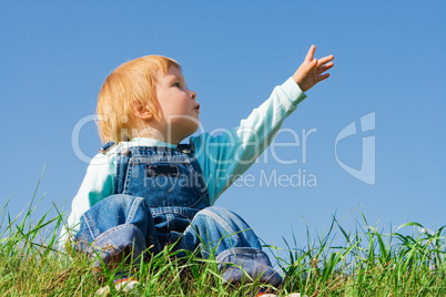 child on green grass