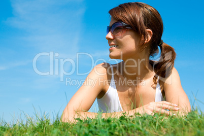 Young woman lying on the green grass