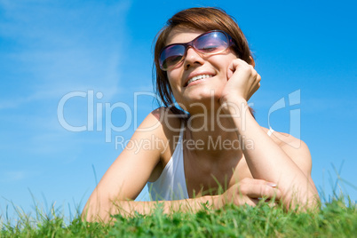 Young woman lying on the green grass