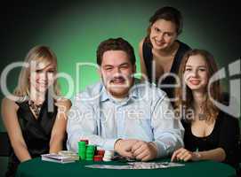 Poker players in casino with cards and chips
