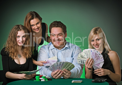 Poker players in casino with cards and chips