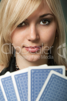 Poker player in casino with cards and chip