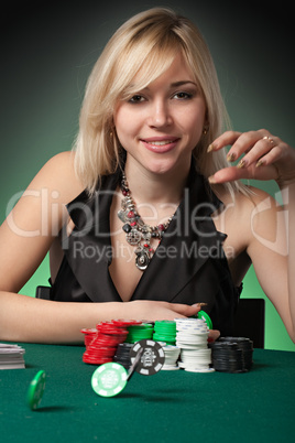 Poker player in casino with cards and chip