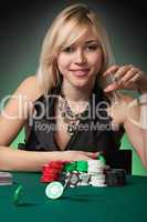 Poker player in casino with cards and chip