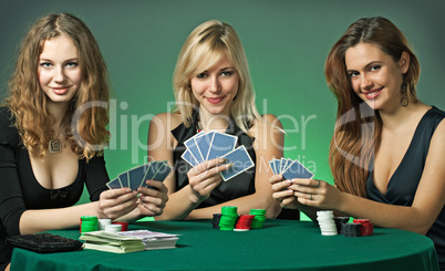 Poker players in casino with cards and chips