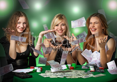 Poker players in casino with cards and chipsv