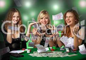 Poker players in casino with cards and chipsv