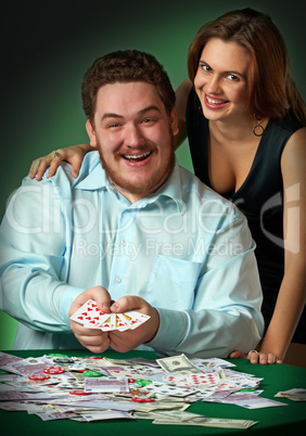 Poker players in casino with cards and chips