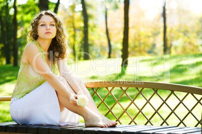 young beauty woman sit on bench