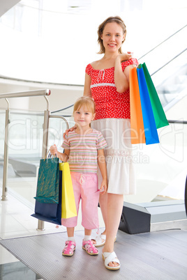 young mother with little doughter in mall