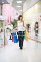 Casual woman walking with shopping bags