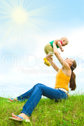 Mother with  baby  on the meadow