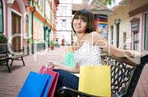 young woman with multi-coloured bags