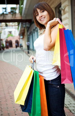 young woman with multi-coloured bags