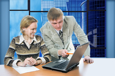 business team man and woman work in office on laptop with view business buildings
