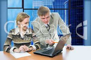 business team man and woman work in office on laptop with view business buildings