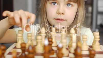 Beautiful little girl learns to play chess 3
