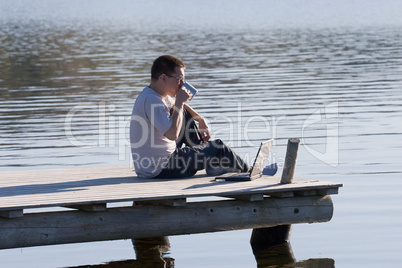 man sitting on pier