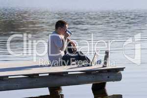 man sitting on pier