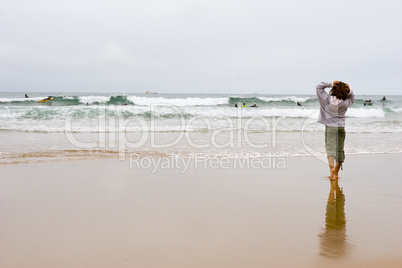 girl looking at surfers