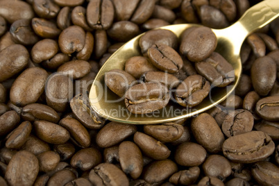 Coffee beans and golden spoon