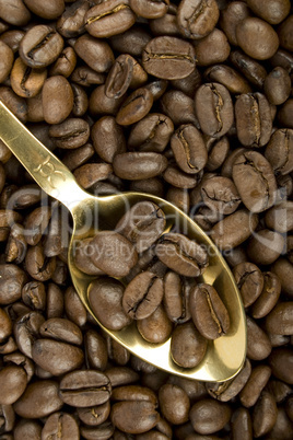 Coffee beans and golden spoon