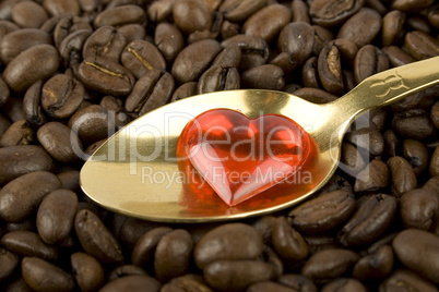 Coffee beans and red heart and golden spoon