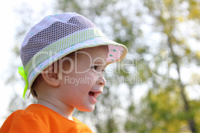 laughing baby in hat outdoor