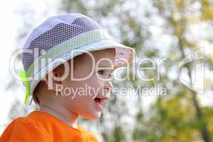 laughing baby in hat outdoor