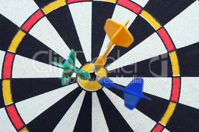 dartboard with darts in aim