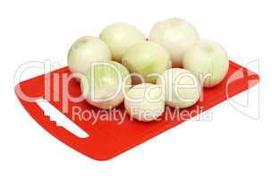 onion on red kitchen board