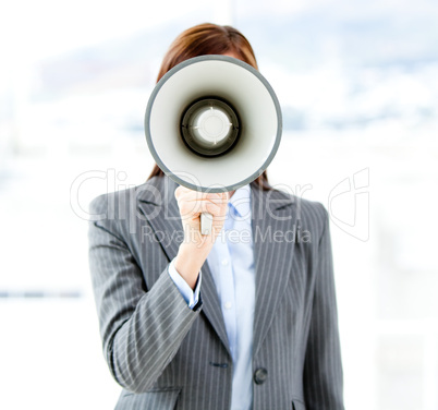 Portrait of an confident businesswoman using a megaphone