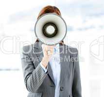 Portrait of an confident businesswoman using a megaphone