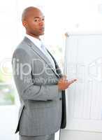 Portrait of a charismatic businessman pointing a white board