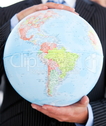 Close-up of a businessman holding a globe