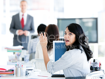 Portrait of a interrested businesswoman raising her hand