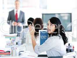 Portrait of a interrested businesswoman raising her hand