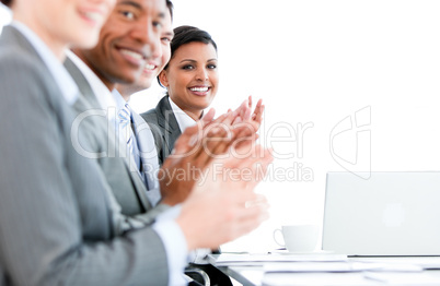 Close up of a multi-ethnic business team applauding a presentati
