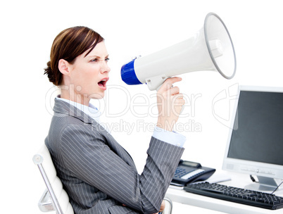Portrait of an angry businesswoman using a megaphone