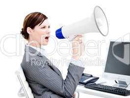 Portrait of an angry businesswoman using a megaphone